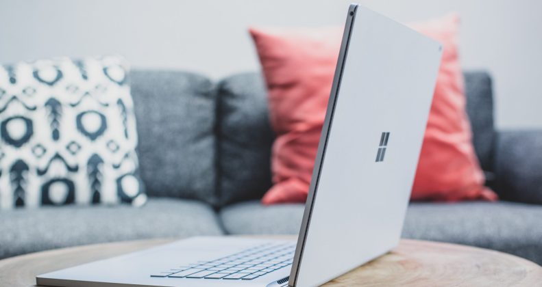 macbook pro on white couch