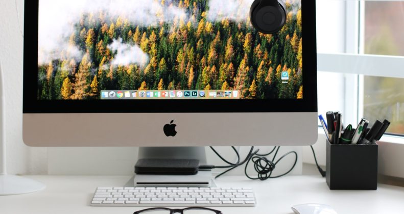 Free Turned on Silver Imac With Might Mouse and Keyboard Stock Photo