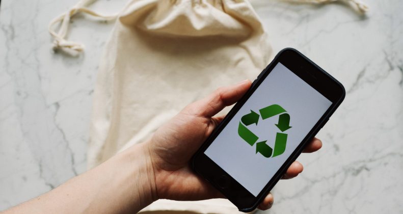 Free Faceless person showing recycle symbol on mobile phone screen Stock Photo